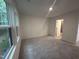 Spacious carpeted bedroom with a large window and an ensuite bathroom at 1546 Crescent Townes Way, Raleigh, NC 27604