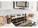 Modern kitchen features stainless steel appliances, sleek white cabinets, and a stylish tile backsplash at 1546 Crescent Townes Way, Raleigh, NC 27604