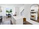 Kitchen island boasts stainless steel sink, white countertops, and seating, adjacent to dining area at 1546 Crescent Townes Way, Raleigh, NC 27604
