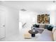 Open-concept living room with neutral sectional, modern decor, and white walls at 1546 Crescent Townes Way, Raleigh, NC 27604