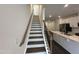 Staircase with wood handrail and white risers leading to the upper level at 1546 Crescent Townes Way, Raleigh, NC 27604