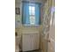 Well-lit bathroom featuring tile flooring, a cabinet, and a shower with curtains at 1721 Daniels Farm Rd, Mebane, NC 27302