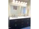 Modern bathroom featuring double sinks, and a large mirror at 1721 Daniels Farm Rd, Mebane, NC 27302