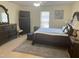 Spacious bedroom featuring tile floors and dark wood furniture at 1721 Daniels Farm Rd, Mebane, NC 27302