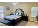 Comfortable bedroom with a ceiling fan, two windows, and a coordinated color scheme at 1721 Daniels Farm Rd, Mebane, NC 27302