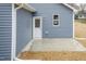 Exterior view of the back entrance, featuring a door and a small concrete patio at 175 David Ln, Roxboro, NC 27573