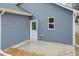 Home's backyard with blue siding and a door leading to the exterior patio at 175 David Ln, Roxboro, NC 27573