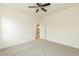 This bedroom has neutral walls, gray carpet, a ceiling fan, and adjoins a doorway to another room at 175 David Ln, Roxboro, NC 27573
