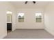 Bedroom featuring neutral walls, plush carpet, two windows, and a glimpse into the bathroom at 175 David Ln, Roxboro, NC 27573