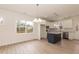 Bright kitchen with white cabinets, stainless steel appliances, granite counters, a navy island, and wood-look floors at 175 David Ln, Roxboro, NC 27573