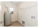 Clean laundry room with storage shelving, connections for washer/dryer, and a bright window at 175 David Ln, Roxboro, NC 27573