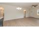 Bright and airy living room featuring modern lighting and sleek, light-colored flooring throughout at 175 David Ln, Roxboro, NC 27573