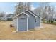 Exterior of the home's rear, showcasing blue siding, a small patio and white trim at 175 David Ln, Roxboro, NC 27573