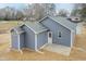 Elevated exterior view of the rear of the home, featuring blue siding, fresh seed and white trim at 175 David Ln, Roxboro, NC 27573