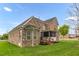 Brick house boasts a screened-in porch and a spacious lawn, perfect for outdoor activities at 1808 Pattersons Mill Rd, Durham, NC 27703