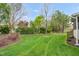 Backyard with lush green grass and beautiful landscaping at 1808 Pattersons Mill Rd, Durham, NC 27703