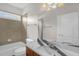 Bathroom with a marble countertop, tiled walls, and bathtub at 1808 Pattersons Mill Rd, Durham, NC 27703