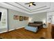 This bedroom offers hardwood floors, ceiling fan, a tray ceiling, and a bench at 1808 Pattersons Mill Rd, Durham, NC 27703