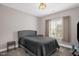 Comfortable bedroom features a window with natural light and a gray comforter at 1808 Pattersons Mill Rd, Durham, NC 27703