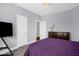 Bedroom with gray walls, carpeted floors, and a purple comforter at 1808 Pattersons Mill Rd, Durham, NC 27703