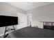 Bedroom with neutral walls, carpeted floors, a dark comforter, and double doors at 1808 Pattersons Mill Rd, Durham, NC 27703