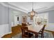 Dining area with light walls, trim and hardwood floors; well lit with plantation shutters at 1808 Pattersons Mill Rd, Durham, NC 27703