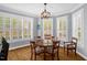 Bright dining room with bay windows, white shutters, and a classic chandelier for elegant dining at 1808 Pattersons Mill Rd, Durham, NC 27703