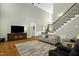 Large living room featuring hard wood floors, media center, stairway and bright windows at 1808 Pattersons Mill Rd, Durham, NC 27703