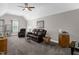 Cozy living room featuring vaulted ceilings, a ceiling fan, and comfortable leather furniture at 1808 Pattersons Mill Rd, Durham, NC 27703