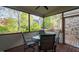 Screened in porch with wooded view and seating at 1808 Pattersons Mill Rd, Durham, NC 27703