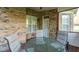 Brick porch with seating and wooded view at 1808 Pattersons Mill Rd, Durham, NC 27703