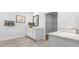 Bright bathroom featuring light colored cabinets, neutral tiling, framed mirror, and white countertops at 1914 Malvina Ct, Graham, NC 27253