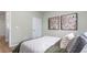 Stylish bedroom with two artworks above the bed and a door in a modern residence at 1914 Malvina Ct, Graham, NC 27253