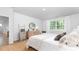 Cozy bedroom with large window view, accent chair, dresser and decorative mirror at 1914 Malvina Ct, Graham, NC 27253