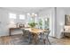 Open dining room area with natural light, wood table, and access to the outdoor patio area at 1914 Malvina Ct, Graham, NC 27253