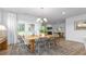 Dining area with wood table and views to back patio through glass doors with white curtains at 1914 Malvina Ct, Graham, NC 27253