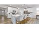 Kitchen boasts a large island with barstool seating, stainless appliances, and crisp white cabinets at 1914 Malvina Ct, Graham, NC 27253