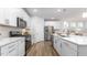 Bright kitchen boasts stainless appliances, white cabinetry, granite countertops and tiled backsplash at 1914 Malvina Ct, Graham, NC 27253