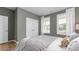 Serene main bedroom features two windows and a door, providing a comfortable and private retreat at 1914 Malvina Ct, Graham, NC 27253