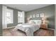 Stylishly decorated main bedroom featuring a large bed, decorative wall art, and bright windows with light curtains at 1914 Malvina Ct, Graham, NC 27253