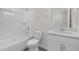 A well-lit bathroom features a bathtub, toilet, and single sink with white cabinets at 1917 Malvina Ct, Graham, NC 27253