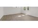 Bright room with a window that offers natural light, light walls and wood-look floors at 1917 Malvina Ct, Graham, NC 27253