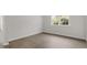 Simple bedroom with a sunlit window, neutral paint, and wood flooring at 1917 Malvina Ct, Graham, NC 27253