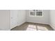 Bedroom featuring a window that offers natural light and wood-look flooring and a white closet door at 1917 Malvina Ct, Graham, NC 27253