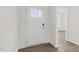 Bright entryway with a white front door and side panel window, showcasing hardwood-style flooring at 1917 Malvina Ct, Graham, NC 27253