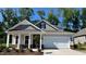 Charming one-story home with a covered front porch, attached garage, and beautiful architectural details at 1917 Malvina Ct, Graham, NC 27253