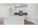 Stylish kitchen boasts an island, gray backsplash, stainless appliances, and white cabinets at 1917 Malvina Ct, Graham, NC 27253