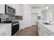 Modern kitchen with stainless steel appliances, quartz countertops, and a stylish backsplash at 1917 Malvina Ct, Graham, NC 27253