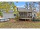 Backyard view with gray siding, an above ground pool, a screened porch and leafy foliage at 198 Hillsdale Dr, Archer Lodge, NC 27527