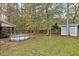 Spacious backyard with scattered fall leaves, a shed and mature trees at 198 Hillsdale Dr, Archer Lodge, NC 27527